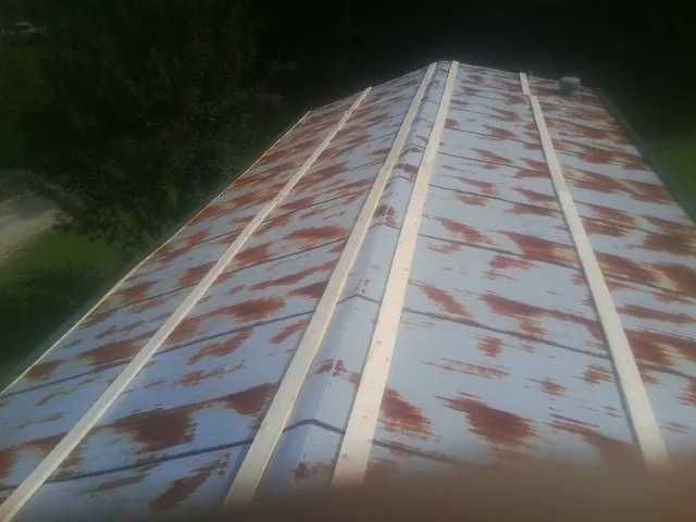 Rusted metal roof panels with new wood purlins before replacement — Storm Damage Roof Repair in Fountain Run by Roofing Brothers
